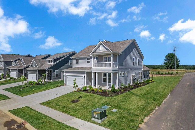698 Conifer Dr, Spring Hill, TN 37174 - view of front of home featuring driveway, a balcony, an attached garage, a porch, and a residential view