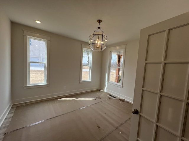 unfurnished dining area featuring visible vents, baseboards, an inviting chandelier, and recessed lighting