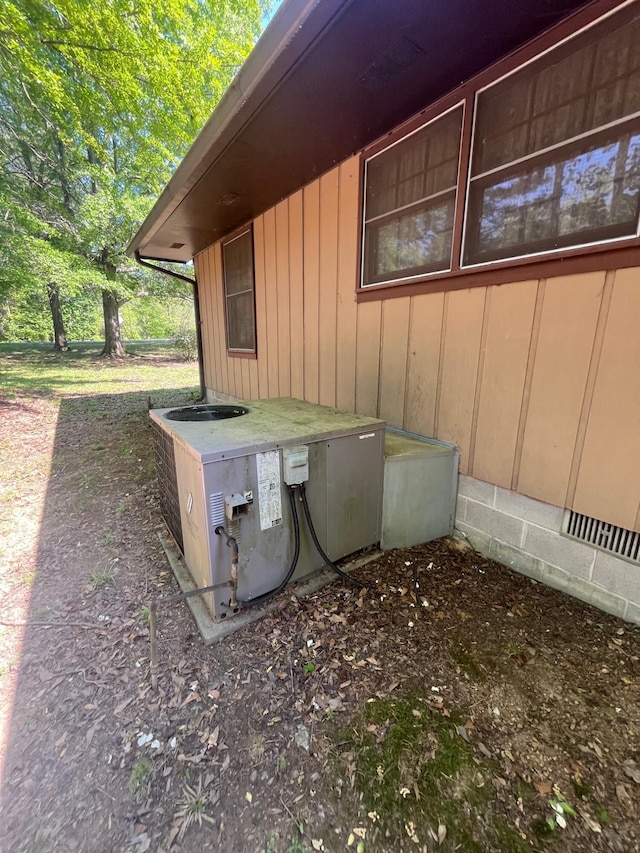 view of home's exterior featuring cooling unit and board and batten siding