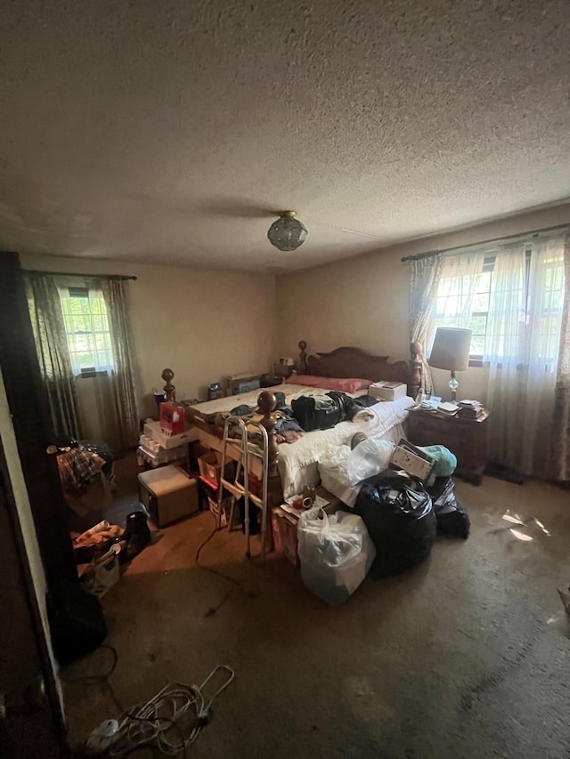 bedroom with carpet flooring and a textured ceiling