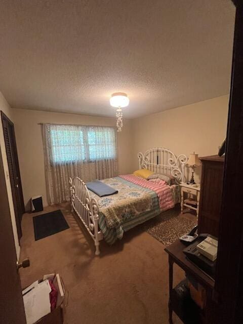 bedroom with carpet and a textured ceiling