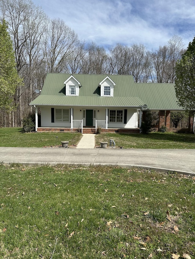 view of front of house featuring a front lawn, brick siding, metal roof, and covered porch