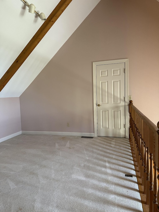 bonus room with baseboards, lofted ceiling, visible vents, and carpet