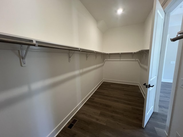 walk in closet featuring visible vents and dark wood-style flooring