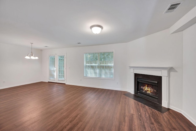 1131 Nashboro Blvd, Nashville, TN 37217 - unfurnished living room with a fireplace with flush hearth, baseboards, visible vents, an inviting chandelier, and dark wood-type flooring