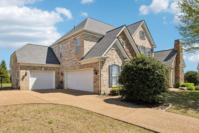 107 Jasmine Ct, Gallatin, TN 37066 - traditional-style home featuring concrete driveway, brick siding, a shingled roof, and a chimney