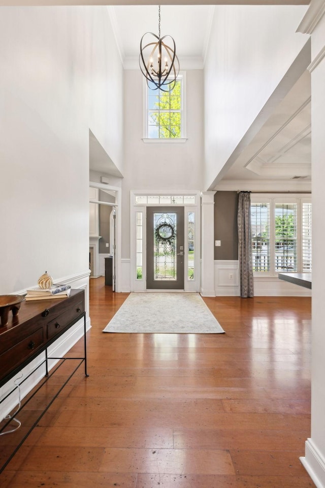 107 Jasmine Ct, Gallatin, TN 37066 - entryway featuring ornamental molding, a chandelier, plenty of natural light, wood-type flooring, and a decorative wall