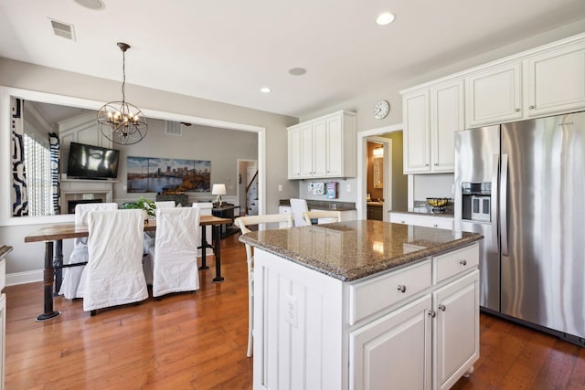 107 Jasmine Ct, Gallatin, TN 37066 - kitchen featuring stainless steel refrigerator with ice dispenser, white cabinetry, a chandelier, dark wood-type flooring, and dark stone countertops