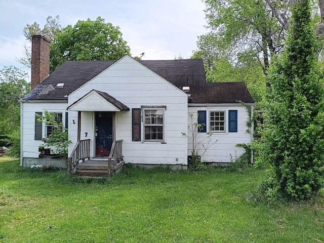 bungalow-style home featuring a chimney and a front lawn