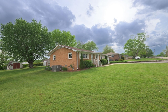 107 Hillis St, Mcminnville, TN 37110 - view of home's exterior featuring brick siding, a lawn, a storage shed, and driveway