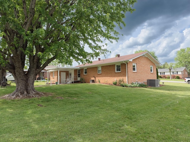107 Hillis St, Mcminnville, TN 37110 - rear view of house with a lawn, brick siding, and cooling unit