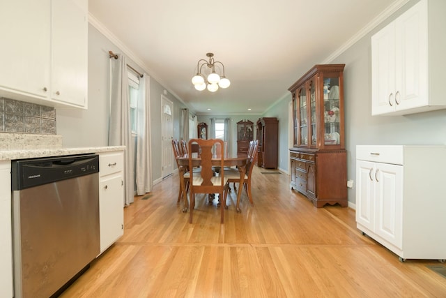 107 Hillis St, Mcminnville, TN 37110 - dining space with baseboards, crown molding, a chandelier, and light wood-style flooring