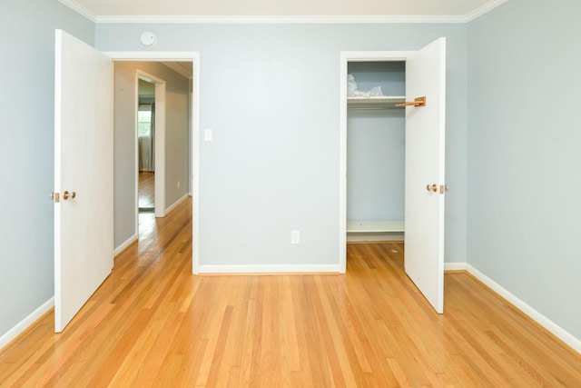 107 Hillis St, Mcminnville, TN 37110 - unfurnished bedroom with light wood-style flooring, a closet, baseboards, and ornamental molding