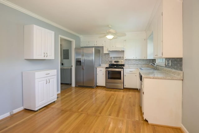 107 Hillis St, Mcminnville, TN 37110 - kitchen featuring white cabinets, stainless steel appliances, light countertops, a ceiling fan, and tasteful backsplash