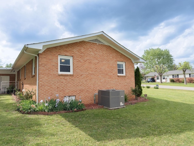 107 Hillis St, Mcminnville, TN 37110 - view of property exterior featuring brick siding, a yard, and central air condition unit