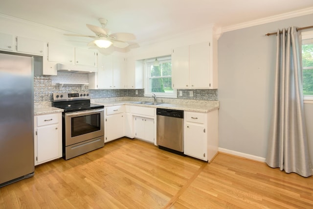 107 Hillis St, Mcminnville, TN 37110 - kitchen featuring crown molding, stainless steel appliances, light countertops, backsplash, and under cabinet range hood