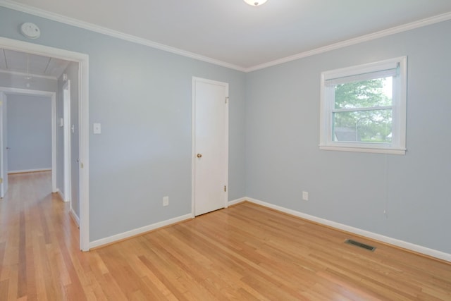 107 Hillis St, Mcminnville, TN 37110 - empty room with visible vents, light wood-style floors, crown molding, baseboards, and attic access