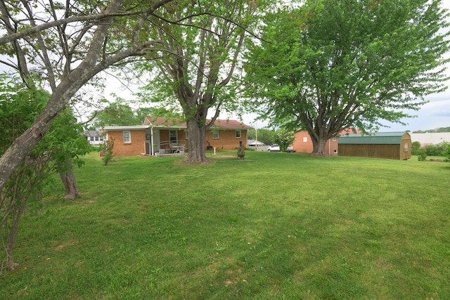 107 Hillis St, Mcminnville, TN 37110 - view of yard with an outdoor structure and a storage shed