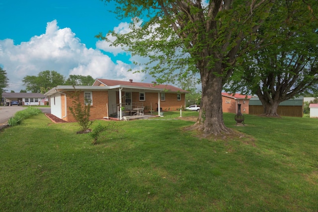 107 Hillis St, Mcminnville, TN 37110 - back of property with a patio, a yard, and brick siding