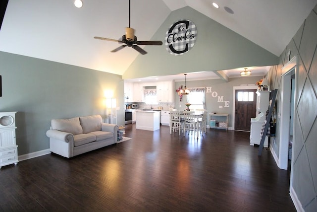 living room featuring dark wood-style flooring, baseboards, recessed lighting, ceiling fan with notable chandelier, and high vaulted ceiling