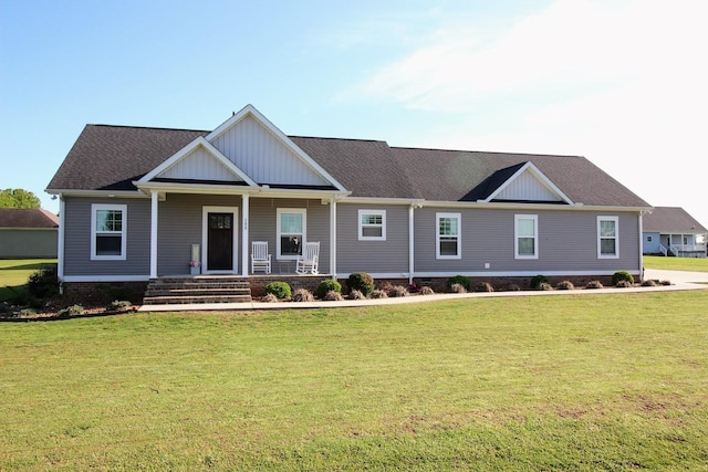 view of front of property with board and batten siding, crawl space, a front yard, and covered porch