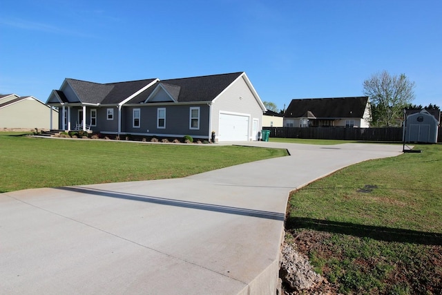 view of front of home featuring fence, driveway, a front yard, and a garage