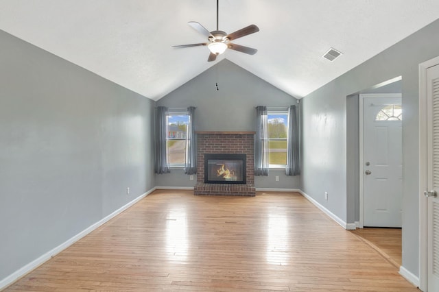 unfurnished living room featuring light wood finished floors, visible vents, a ceiling fan, and a wealth of natural light