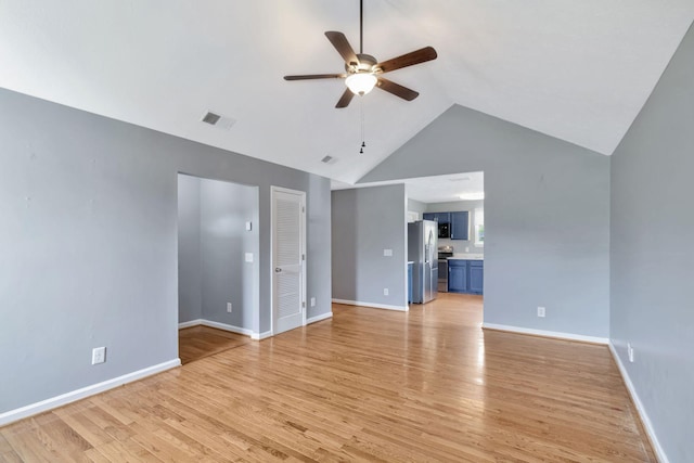 interior space with baseboards, a ceiling fan, visible vents, and light wood-style flooring