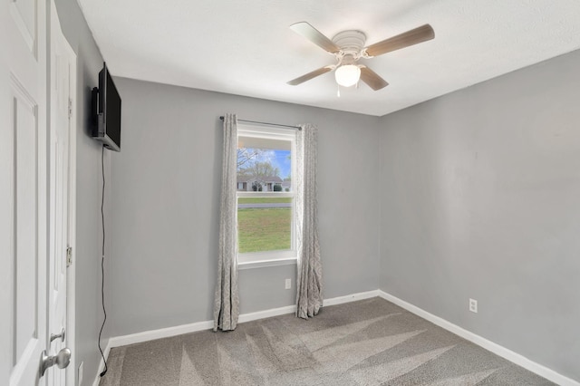 unfurnished room with baseboards, a ceiling fan, and carpet floors