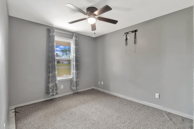 empty room featuring a ceiling fan, baseboards, and carpet floors