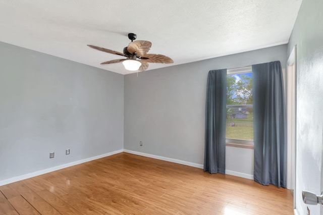 empty room featuring light wood-type flooring, baseboards, and ceiling fan