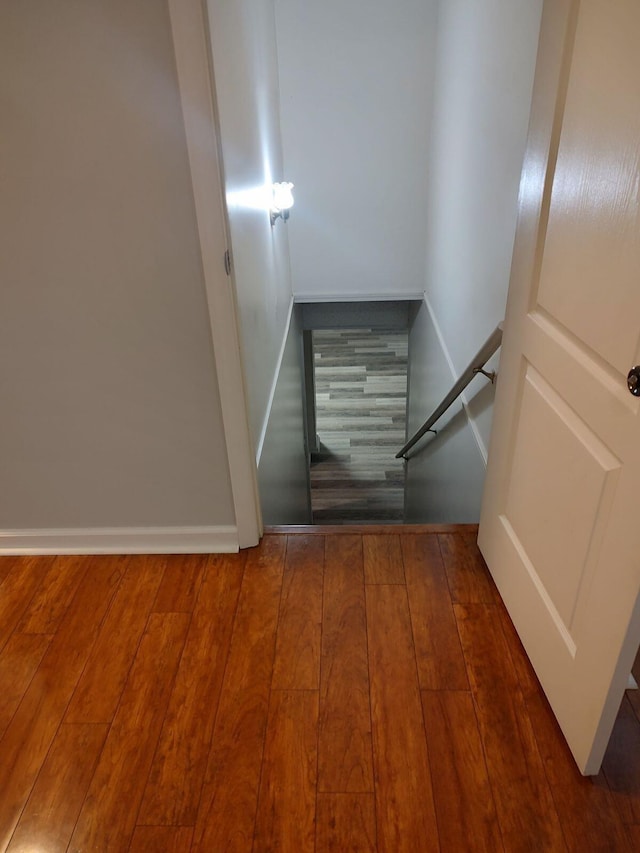 stairs featuring hardwood / wood-style flooring and baseboards