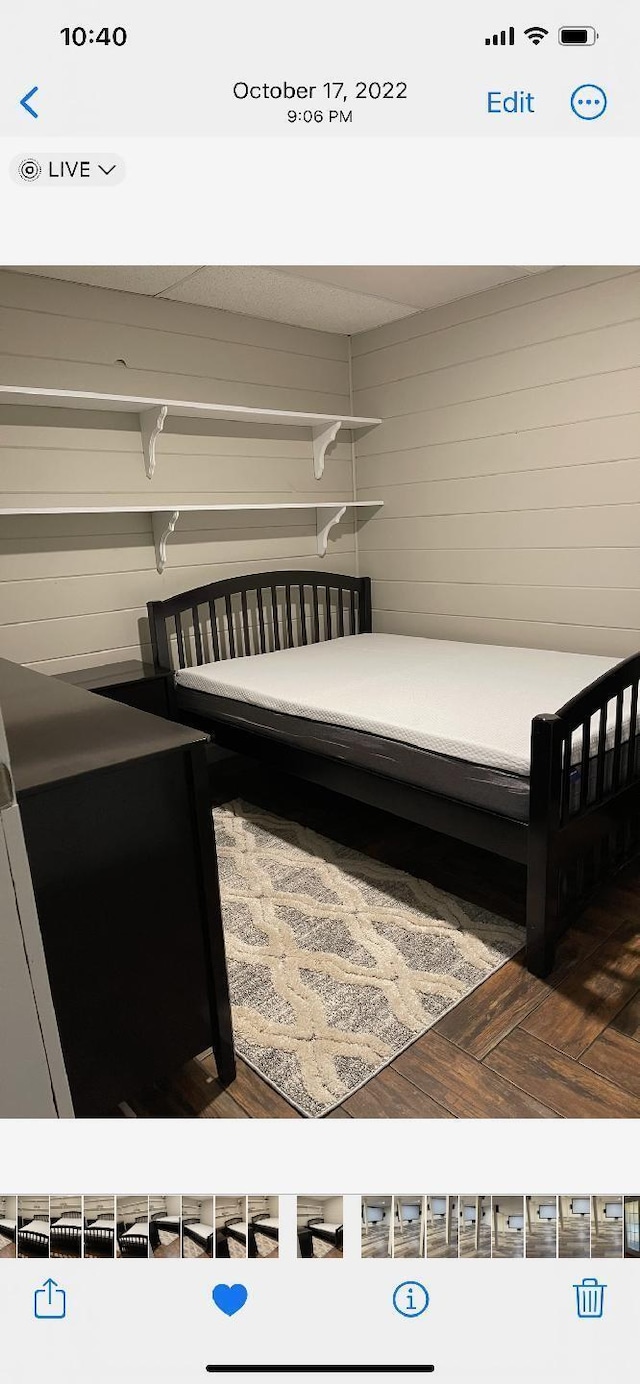bedroom featuring wooden walls
