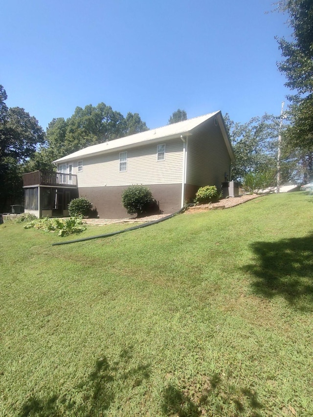 view of side of home featuring a yard