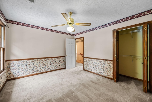 5712 Spring House Way, Brentwood, TN 37027 - unfurnished bedroom with wallpapered walls, a closet, carpet floors, a textured ceiling, and a ceiling fan