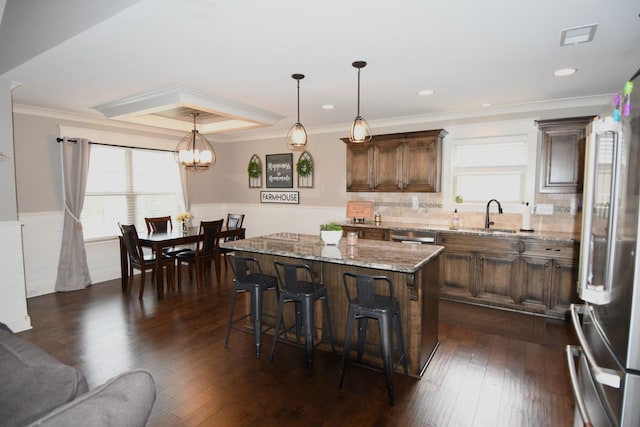 146 Neecee Dr, Smyrna, TN 37167 - kitchen with light stone counters, a breakfast bar, appliances with stainless steel finishes, a sink, and a center island
