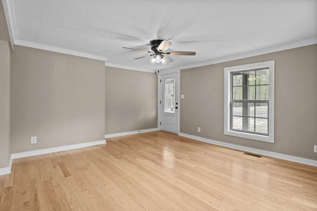 unfurnished room with baseboards, visible vents, light wood-style floors, and ceiling fan