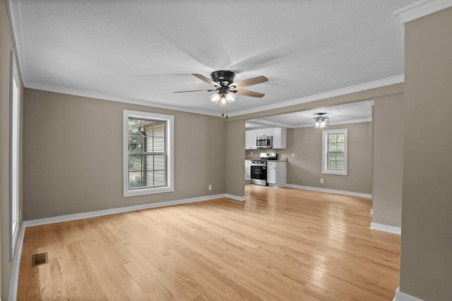 unfurnished living room with light wood-style flooring, visible vents, crown molding, and a ceiling fan