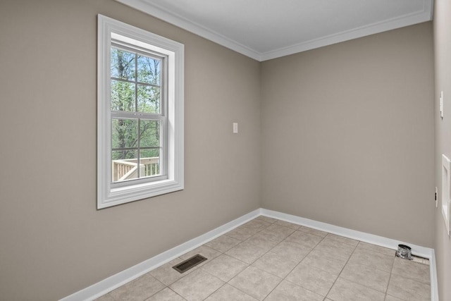 empty room featuring baseboards, crown molding, visible vents, and light tile patterned floors
