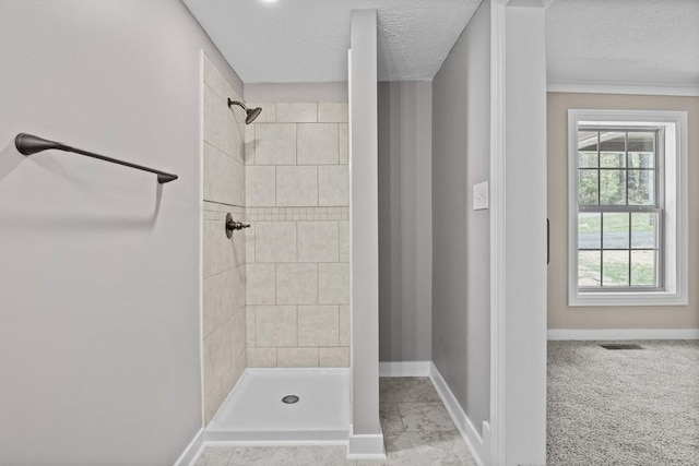full bathroom with baseboards, visible vents, and tiled shower