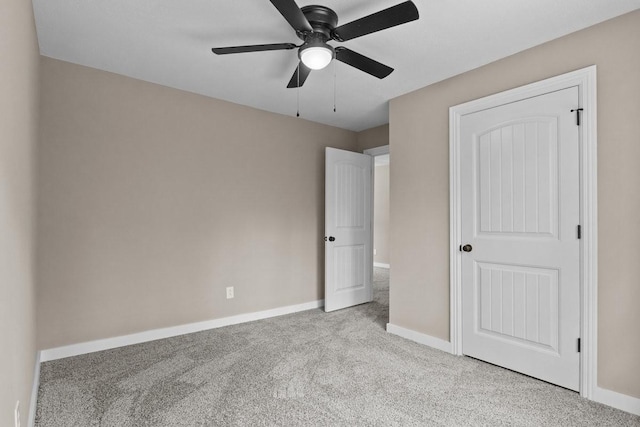 unfurnished bedroom featuring baseboards, a ceiling fan, and carpet flooring