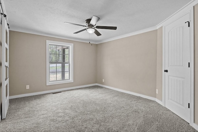 carpeted empty room with visible vents, ornamental molding, a textured ceiling, and ceiling fan