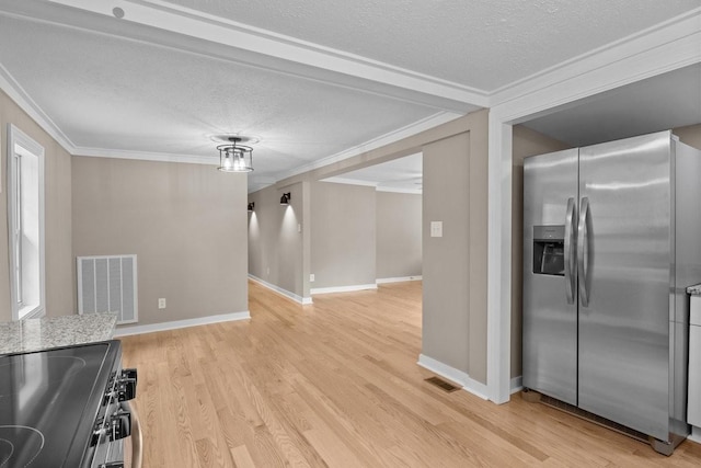 kitchen with stainless steel refrigerator with ice dispenser, a textured ceiling, visible vents, and light wood-type flooring