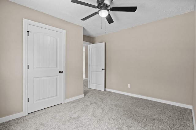 unfurnished bedroom with baseboards, carpet floors, and ceiling fan