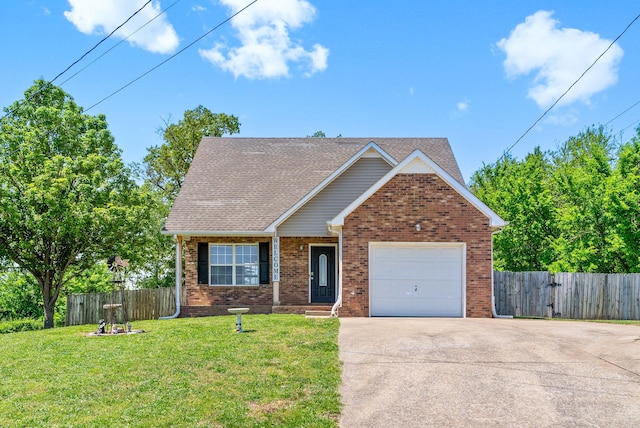 view of front of home featuring a front lawn, fence, brick siding, an attached garage, and driveway