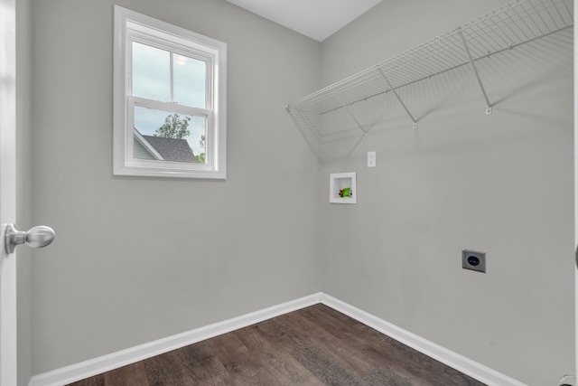 washroom with hookup for a washing machine, electric dryer hookup, dark wood finished floors, baseboards, and laundry area