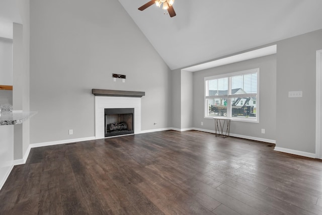 unfurnished living room featuring a fireplace, a ceiling fan, high vaulted ceiling, and dark wood-style floors