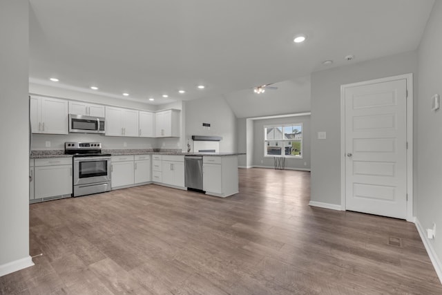 kitchen with recessed lighting, ceiling fan, a peninsula, appliances with stainless steel finishes, and white cabinetry
