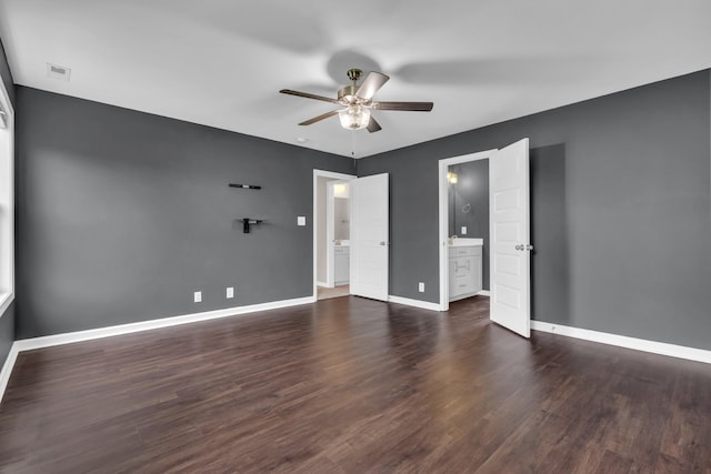 empty room featuring baseboards, a ceiling fan, wood finished floors, and visible vents
