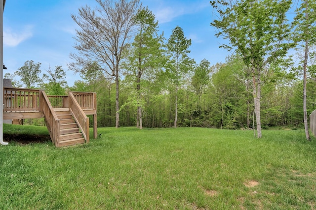 view of yard featuring a deck and stairs